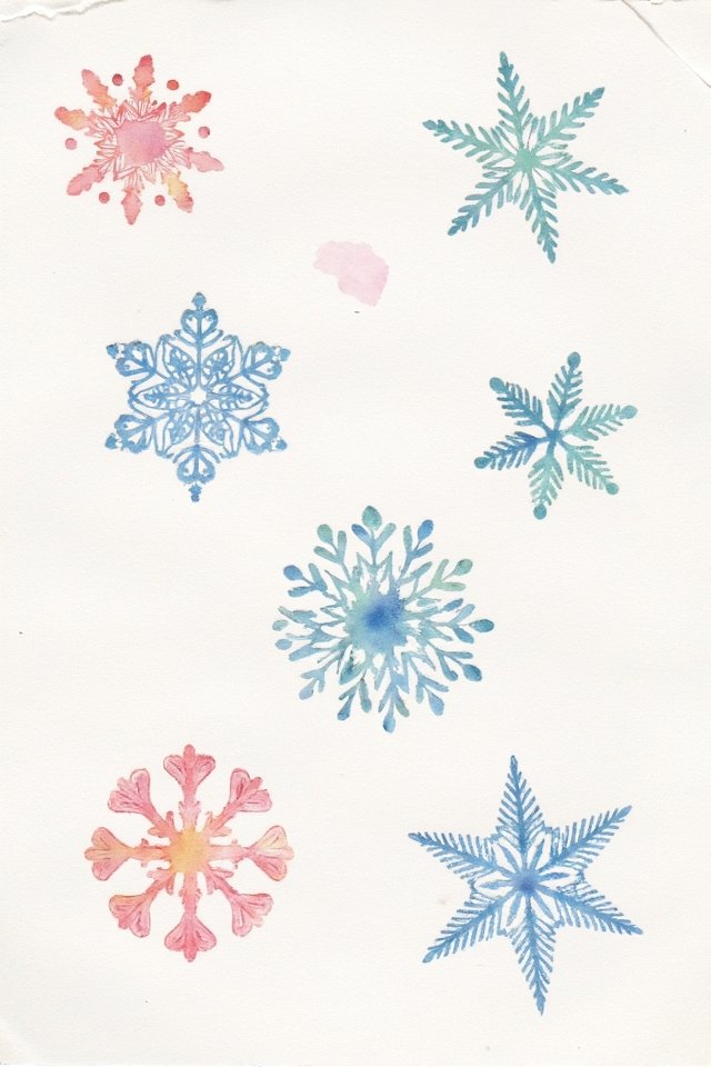 Watercolor snowflakes in vibrant blue, green, and red hues on a white background, showcasing intricate designs.