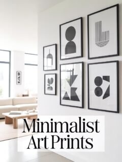 Minimalist art prints on a white wall in a modern living room, featuring abstract geometric designs in black frames.